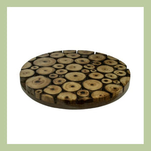 a wooden trivet made from mango wood branch slices on a white background