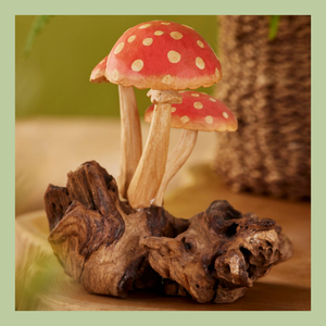 three hanging felted toadstool decorations on a white background