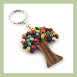 A wooden tree keyring with coloured wooden beads as leaves on a white background