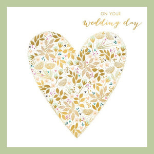 An image of a heart in the centre of a white background with leaves and writing top right saying on your wedding day