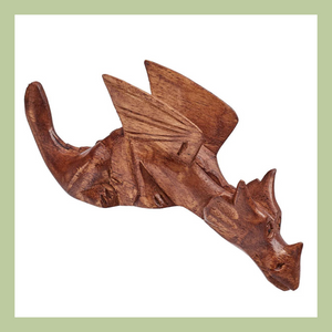 a wooden carved shelf dragon with head looking down