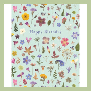 a green birthday card with storeybook design