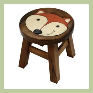 a wooden child's stool with craved and painted lion face