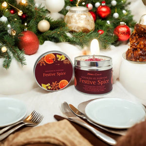 Festive Spice candles on a table with Christmas decorations