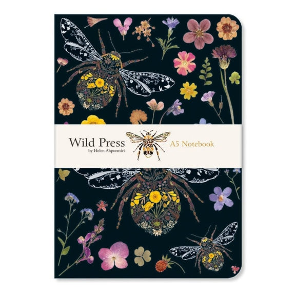 Notebook with floral and insect design on a dark background