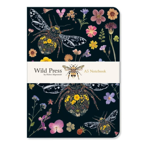 Notebook with floral and insect design on a dark background