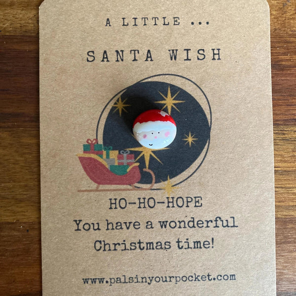 Kraft paper card with Christmas-themed design and text on a wooden surface
