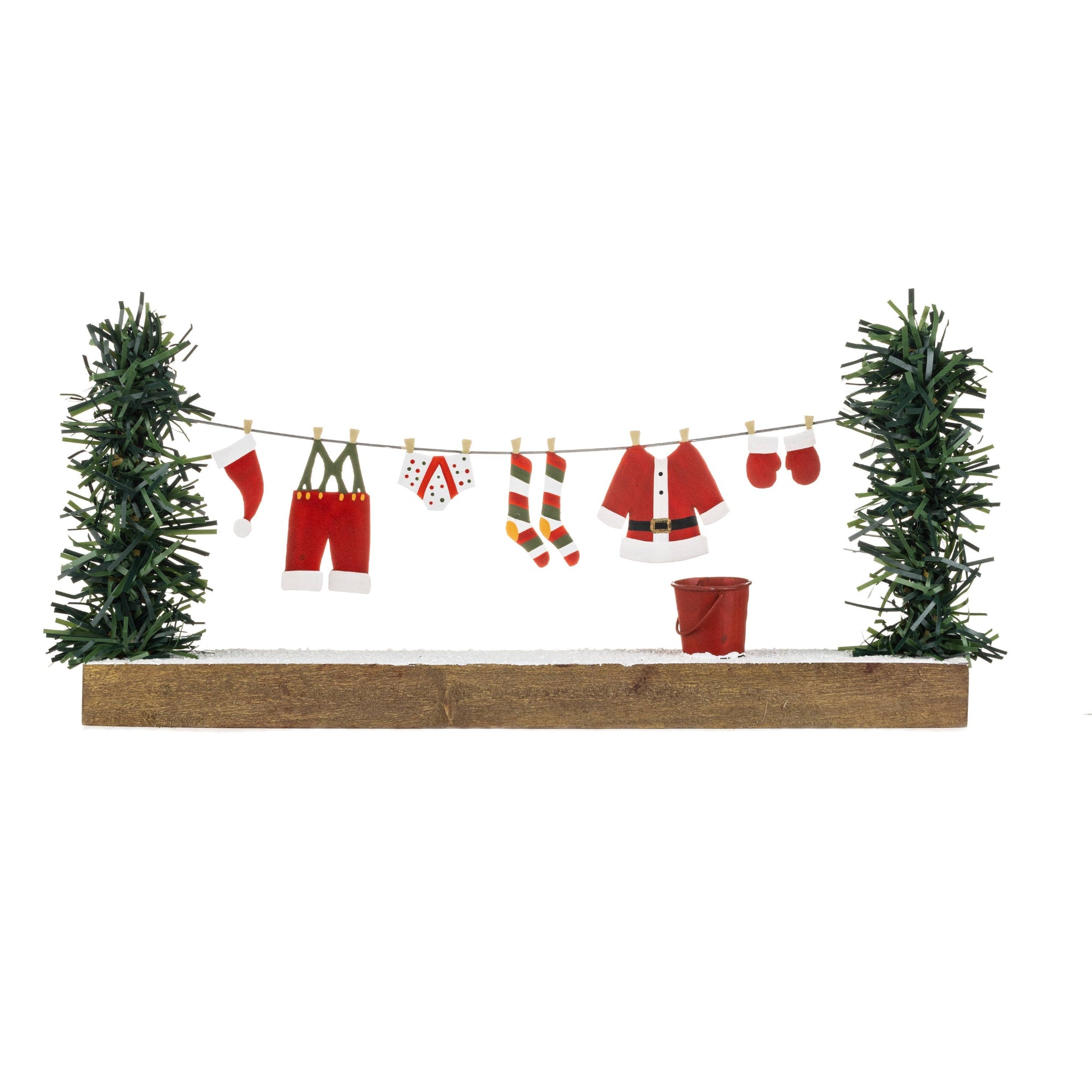 Decorative setup with Christmas-themed items on a clothesline between two trees.
