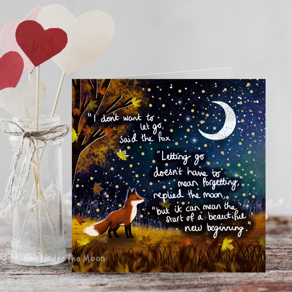 Card with fox and moon illustration and inspirational quote, next to a jar with heart-shaped sticks.