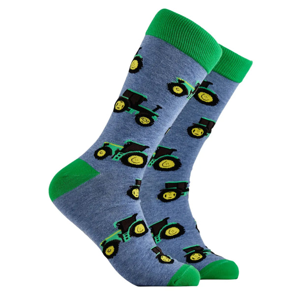 Blue socks with green tractor patterns on a white background