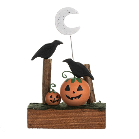 Halloween-themed decorative piece with pumpkins, crows, and a moon on a white background