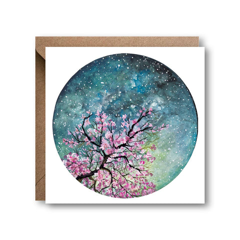 Greeting card with cherry blossom tree design on a starry night sky