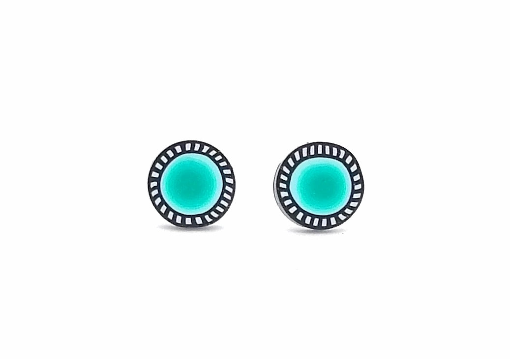 Pair of round earrings with turquoise centers and black and white striped borders on a white background.