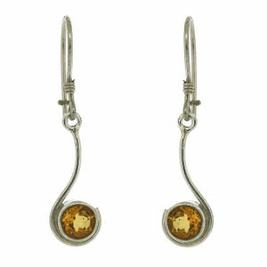 Silver earrings with round amber stones on a white background