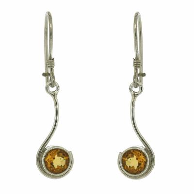 Silver earrings with round amber stones on a white background