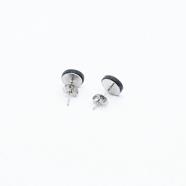 Pair of silver stud earrings on a white background