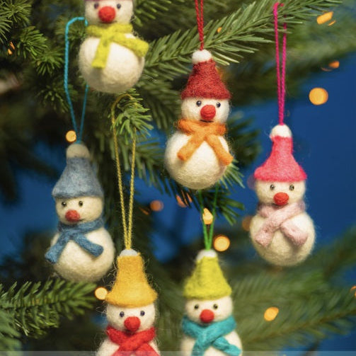 Colorful snowman ornaments with hats and scarves on a Christmas tree.