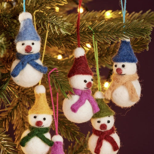 Set of small snowman ornaments with colorful hats and scarves on a Christmas tree.
