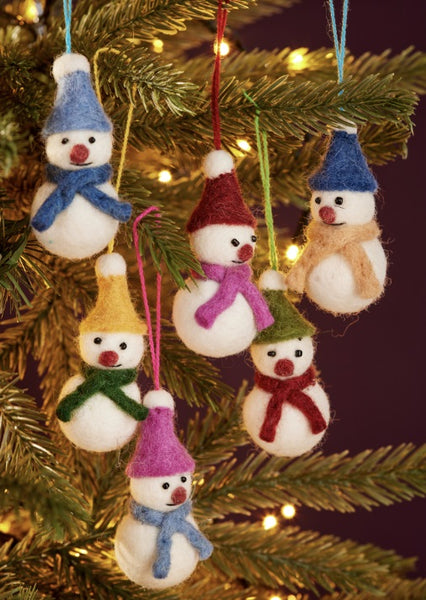 Set of snowman ornaments with colorful hats and scarves hanging on a decorated Christmas tree.