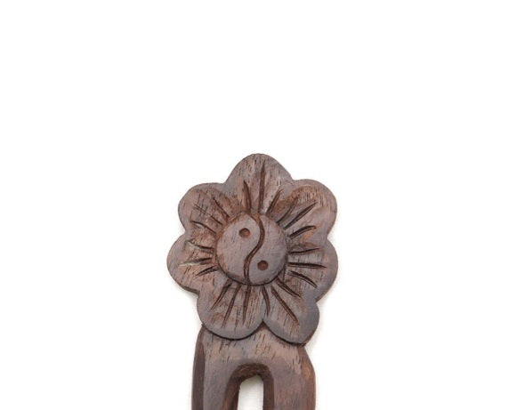 Wooden hair clip with floral design on a white background