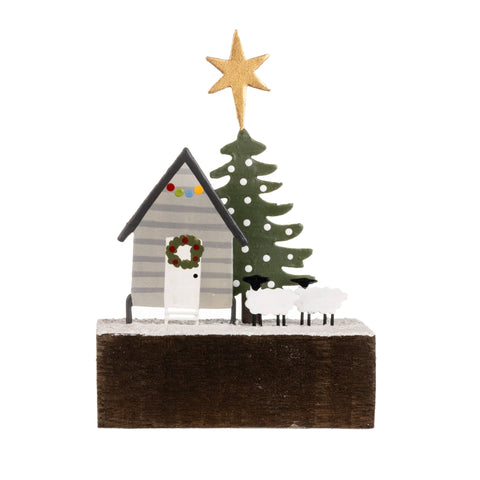 Decorative Christmas scene with a house, tree, and star on a white background