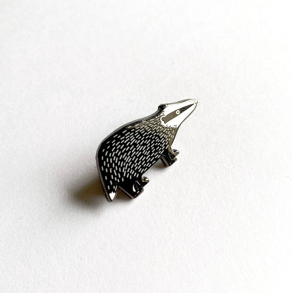 Pin with a detailed badger design on a white background