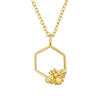 Gold necklace with a hexagonal pendant featuring a bee design on a white background