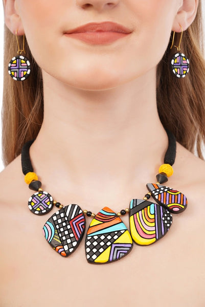 Colorful necklace and earrings on a person with a blurred background