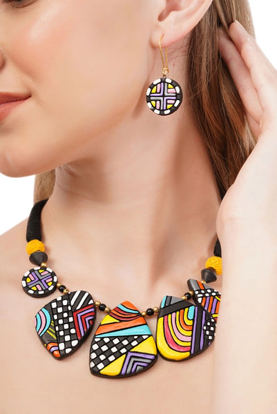 Colorful geometric necklace and earrings on a model against a white background