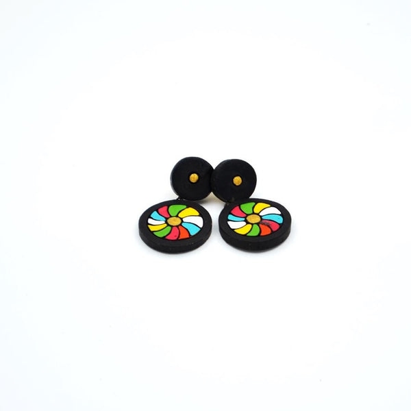 Pair of earrings with colorful wheel designs on a white background