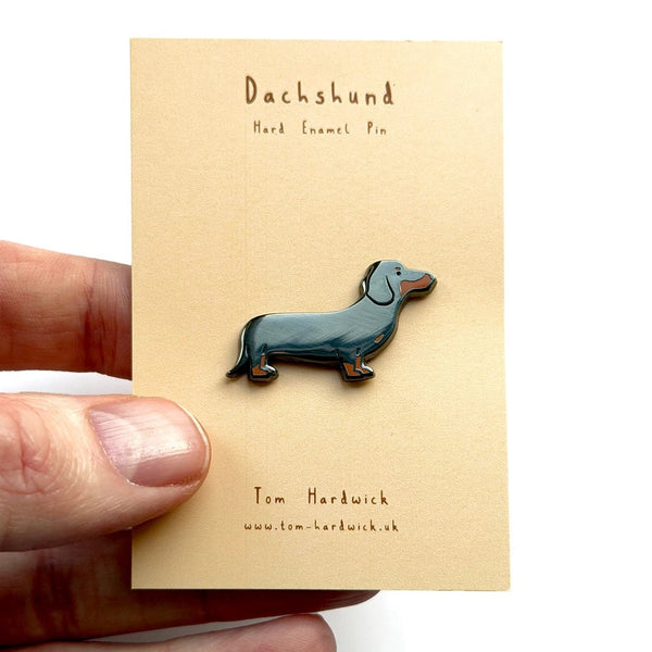 Dachshund enamel pin held on a card with 'Tom Hardwick' branding.