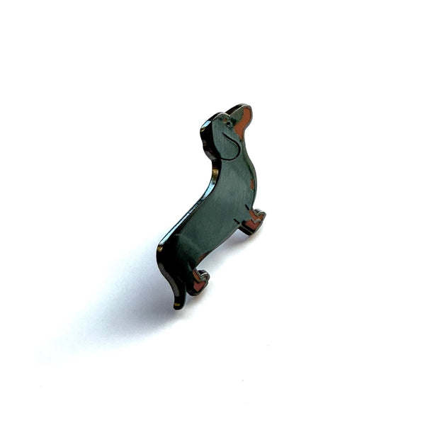 Dog-shaped brooch on a white background