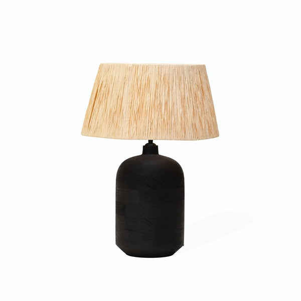 Black table lamp with a beige lampshade on a white background