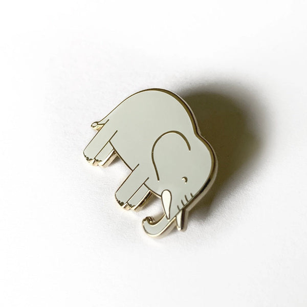 White elephant-shaped pin on a white background