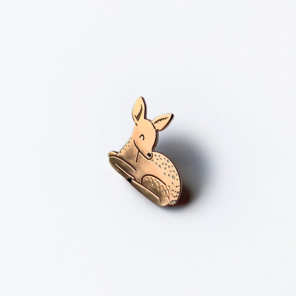 A small gold-toned deer-shaped ring with a textured spotted pattern, photographed on a clean white background with a soft shadow.