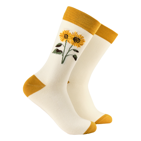 White socks with yellow sunflower design and matching cuffs and toes on a white background