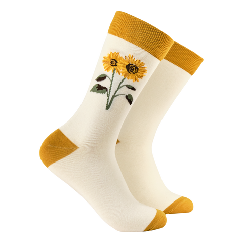 White socks with yellow sunflower design and matching cuffs and toes on a white background