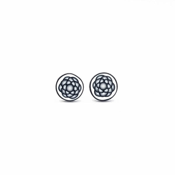 Geometric grey black and white stud earrings on a white background