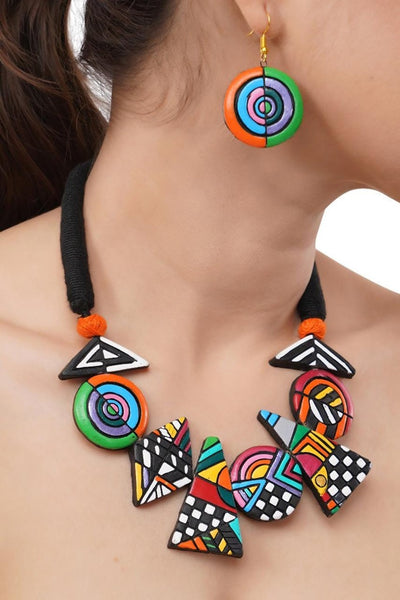 Colorful geometric necklace and earrings on a person