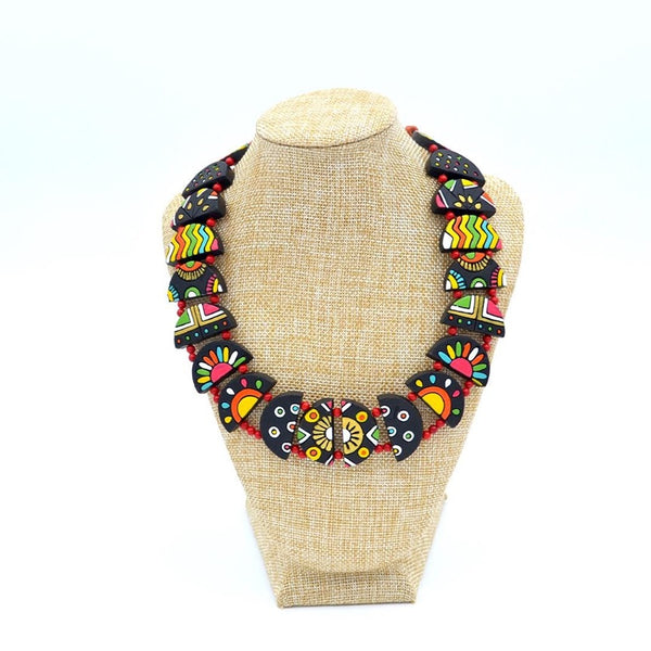 Colorful necklace on a mannequin bust against a white background