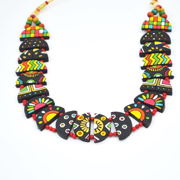 Colorful necklace with black, red, yellow, and green patterns on a white background