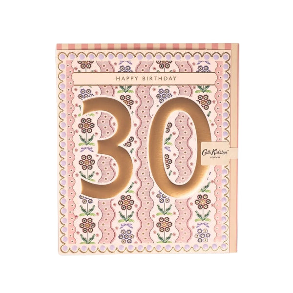 A 30th birthday card by Cath Kidston, featuring a pink and beige floral pattern with large cutout numbers '30' and a small ribbon tag.