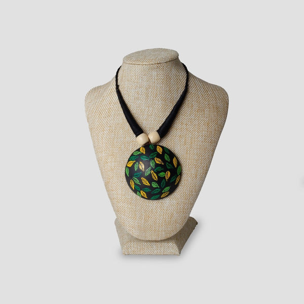 Necklace with a round pendant on a mannequin bust against a white background