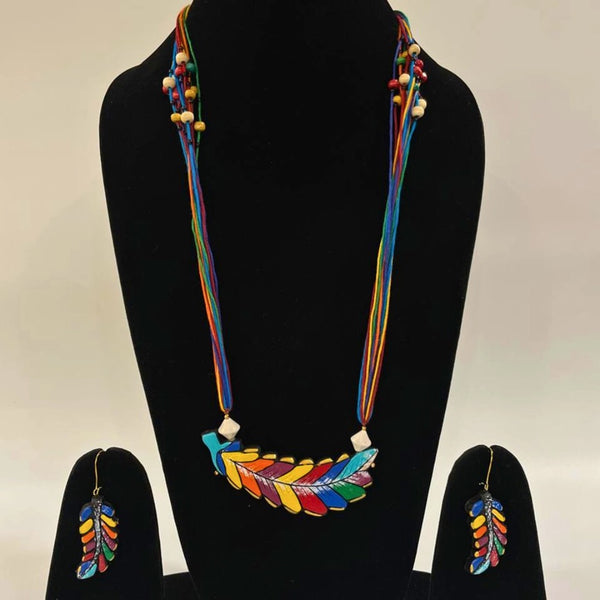 Colorful necklace and earrings set on a black mannequin with a beige background