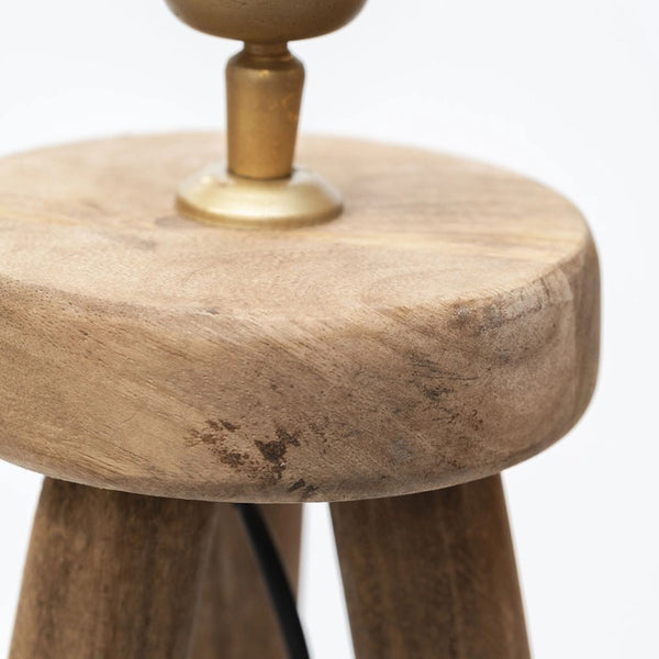 Wooden stool with a brass base on a white background