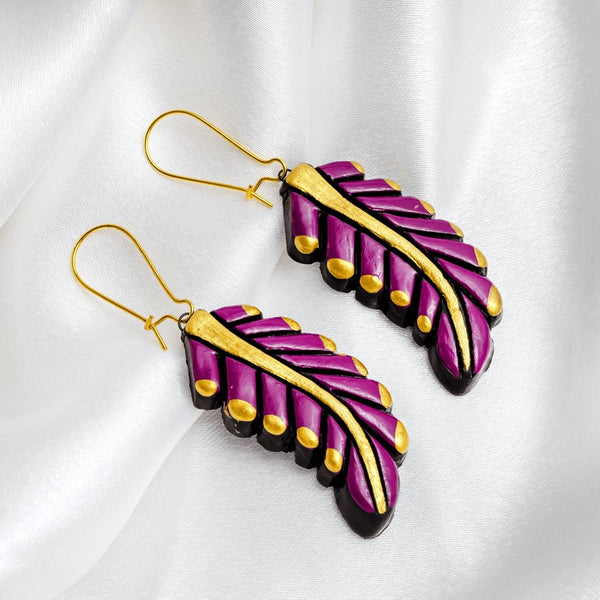 Purple and gold feather-shaped earrings on a white background