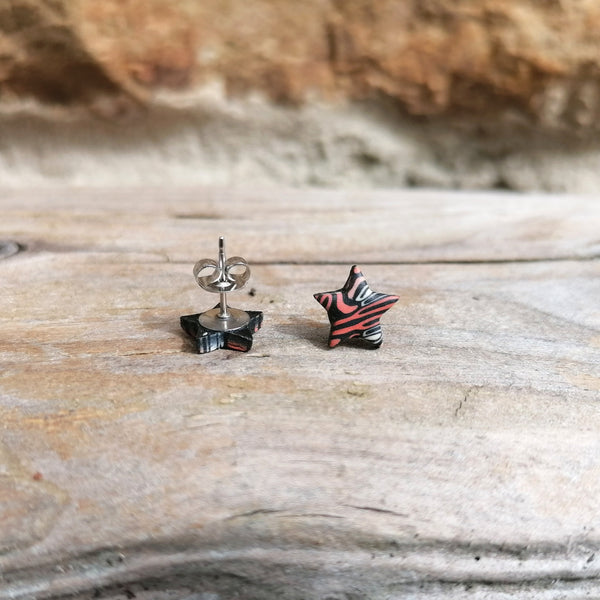 Pair of star-shaped earrings on a wooden surface