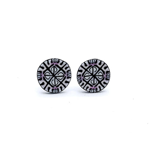 Pair of round black and white patterned earrings on a white background