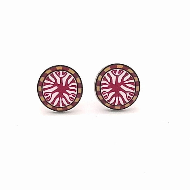 Pair of round earrings with a pink and gold design on a white background