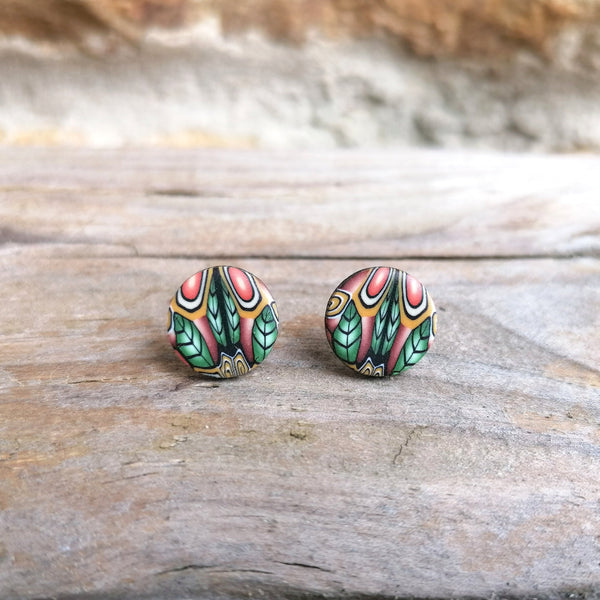 Pair of colorful earrings on a wooden surface